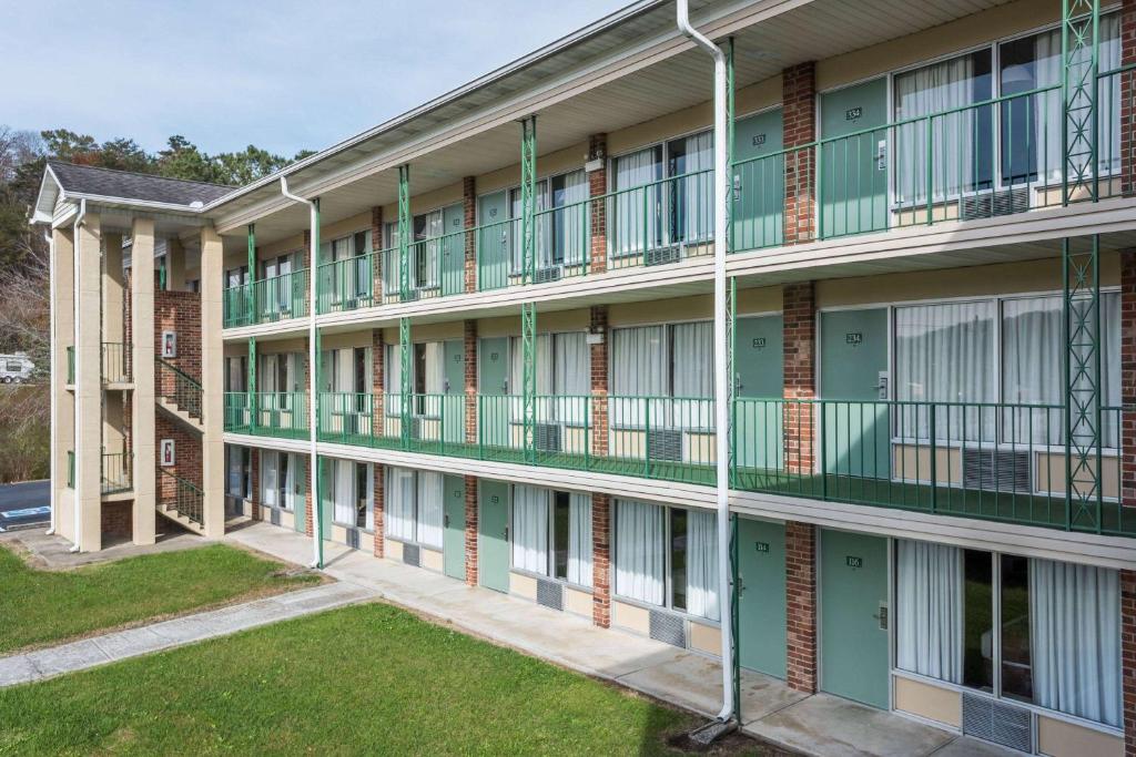 an exterior view of a building with green balconies at Days Inn by Wyndham Jellico - Tennessee State Line in Jellico