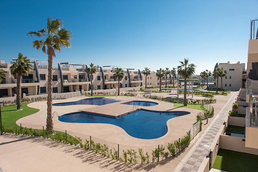 uma vista aérea de um resort com uma piscina e palmeiras em Playa Elisa Bay 108-113 em Pilar de la Horadada