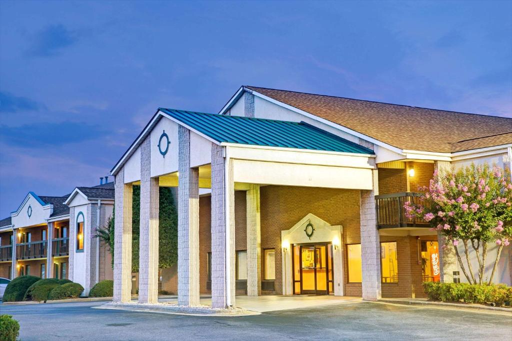 a rendering of a hotel building with a parking lot at Days Inn by Wyndham Mooresville Lake Norman in Mooresville