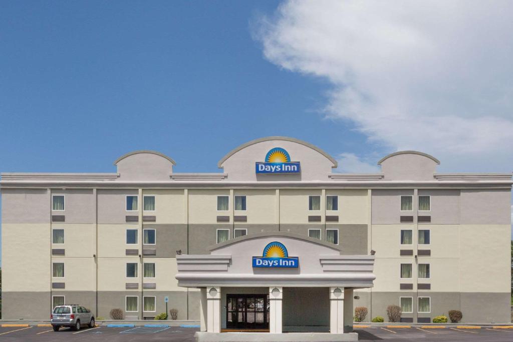 
a large building with a large clock on the front of it at Days Inn by Wyndham Wilkes Barre in Wilkes-Barre
