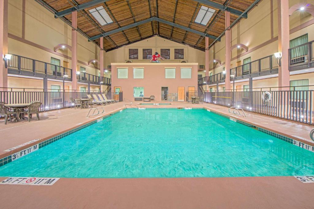 a large swimming pool in a large building at Days Inn by Wyndham Lubbock South in Lubbock