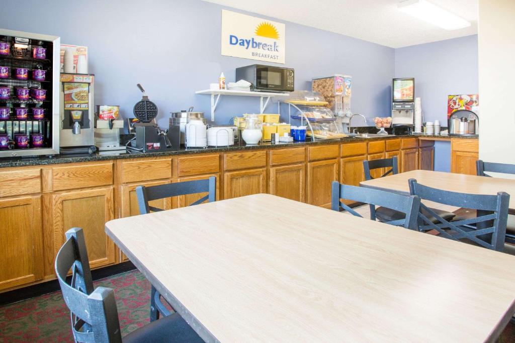 a restaurant with tables and chairs and a counter at Days Inn by Wyndham Lexington NE in Lexington