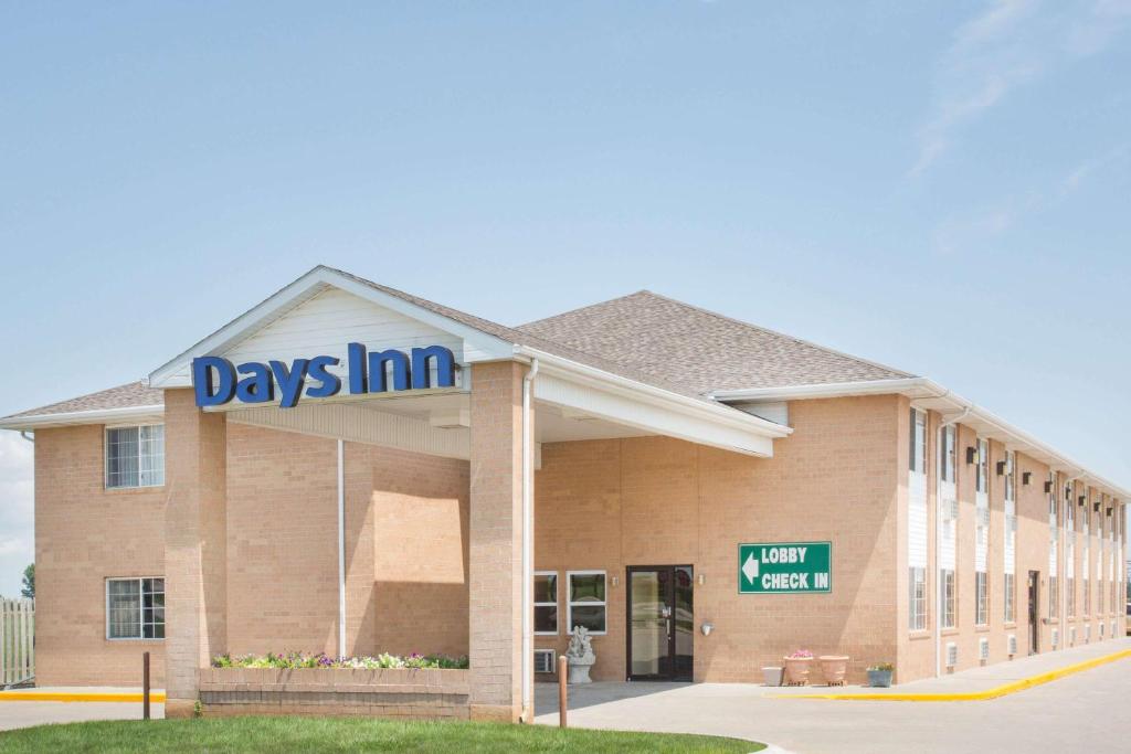 a day inn sign on the front of a building at Days Inn by Wyndham Lexington NE in Lexington