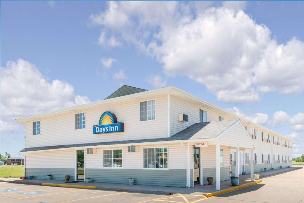 a building with a sign on the side of it at Days Inn by Wyndham Great Bend in Great Bend