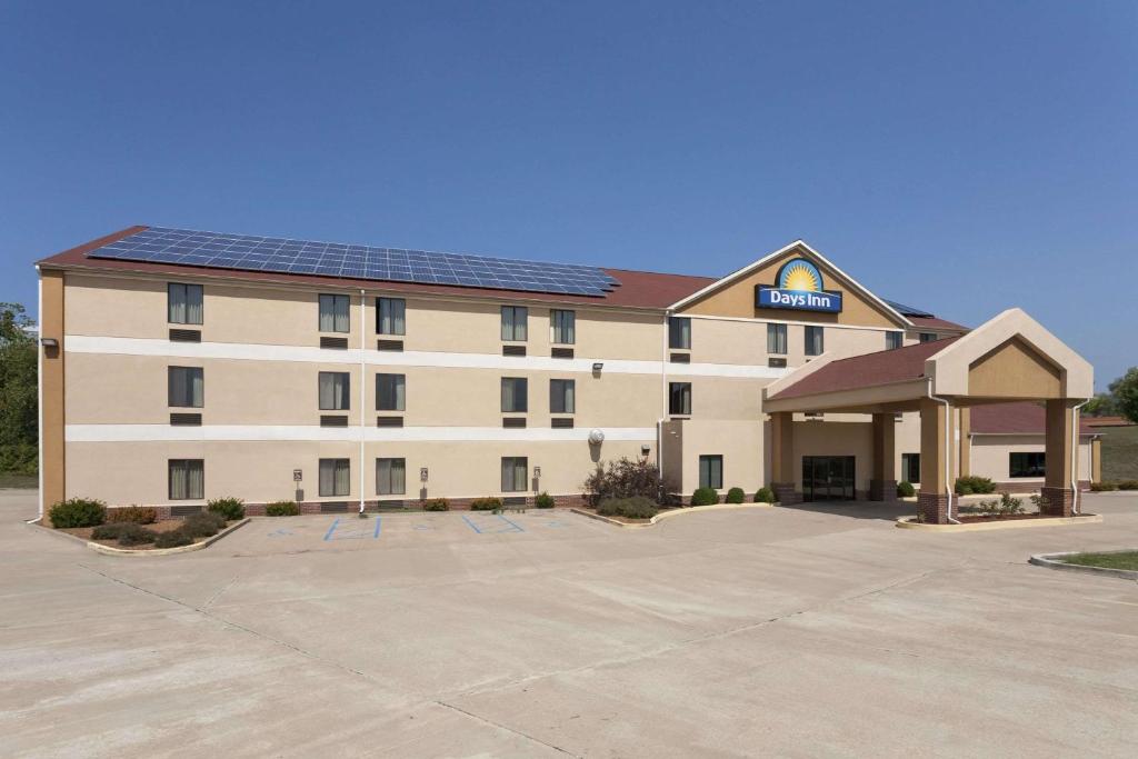 a hotel with a building with a solar roof at Days Inn by Wyndham Jefferson City in Jefferson City