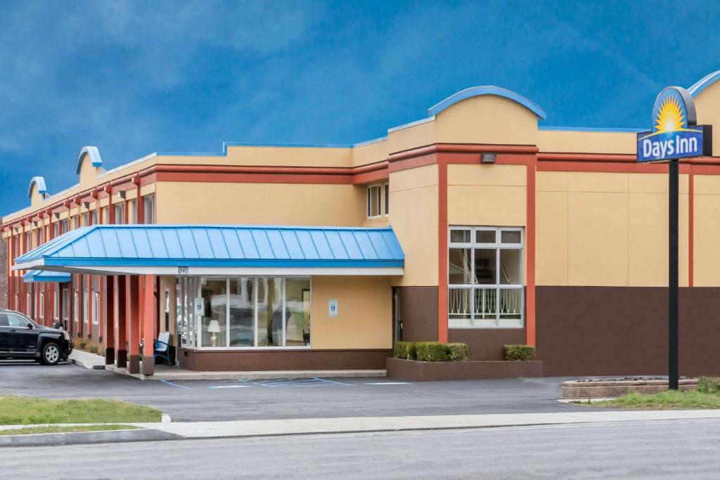 a mcdonalds building with a sign in front of it at Days Inn by Wyndham Albany SUNY in Albany