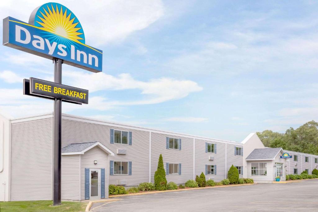 una señal frente a un edificio en Days Inn by Wyndham Cedar Falls- University Plaza en Cedar Falls