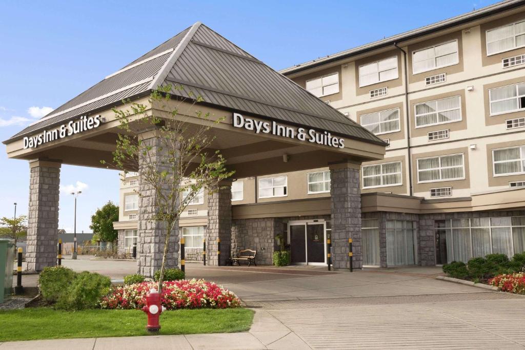a building with a sign for days inn and suites at Days Inn & Suites by Wyndham Langley in Langley