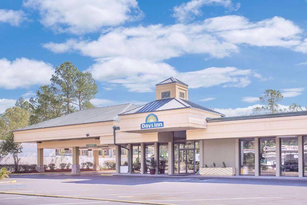 a building with a clock tower on top of it at Days Inn by Wyndham Attalla in Attalla