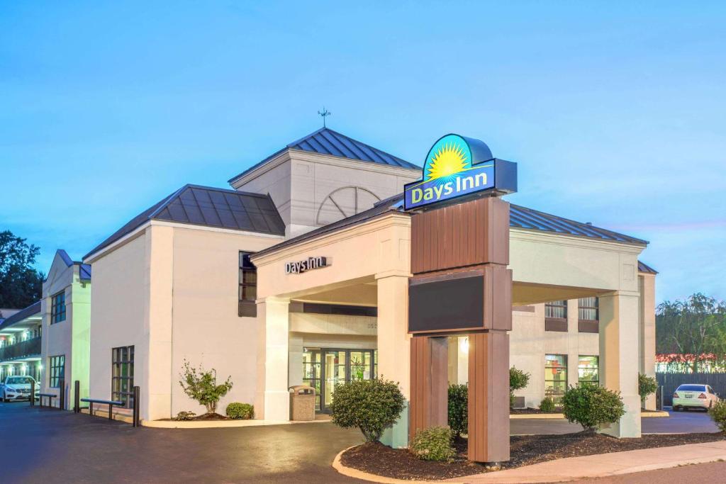 a large building with a clock on the front of it at Days Inn by Wyndham Salem in Salem