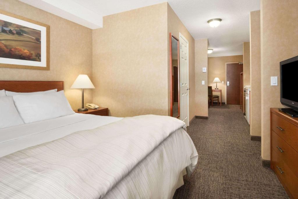 Postel nebo postele na pokoji v ubytování Days Inn & Suites by Wyndham Cochrane