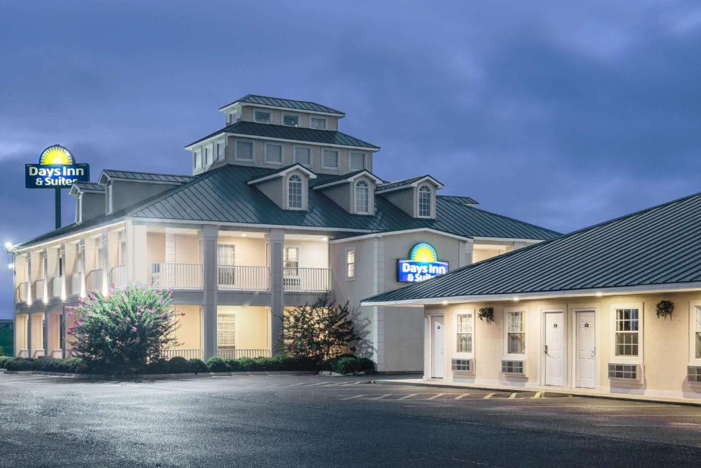 a large building with a clock tower on top of it at Days Inn by Wyndham Trumann AR in Trumann