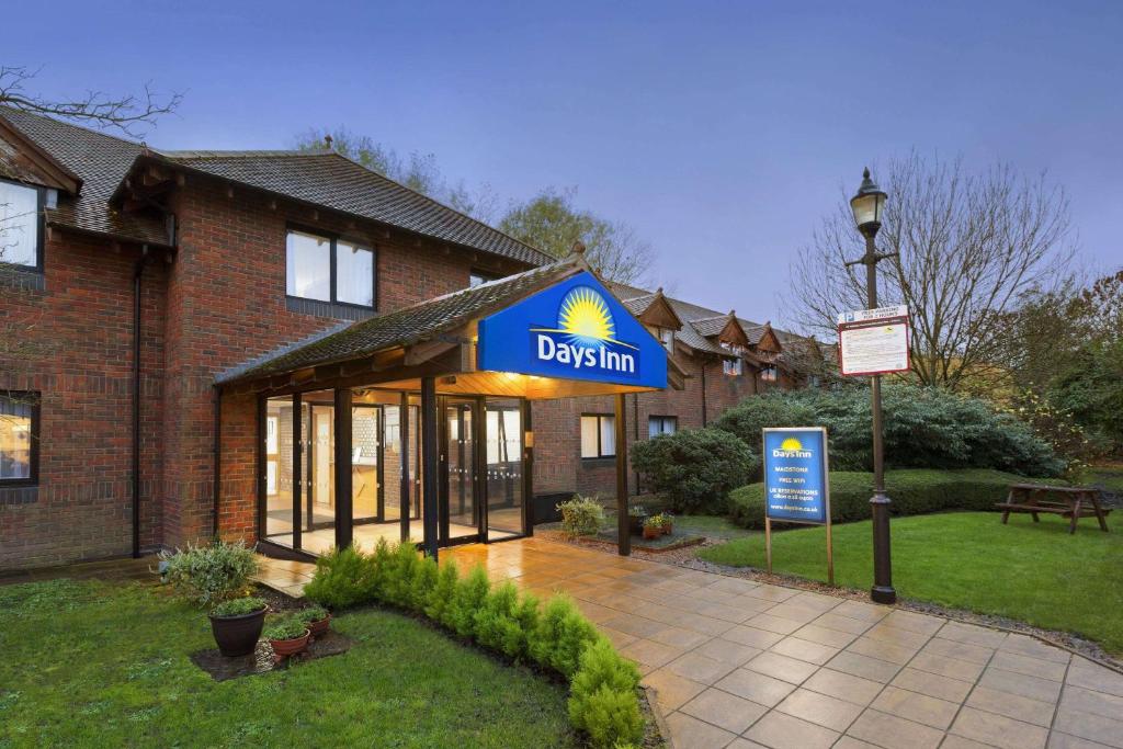a drexium sign in front of a building at Days Inn Maidstone in Maidstone