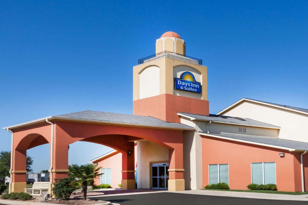 a building with a clock tower on top of it at Days Inn & Suites by Wyndham Marquez in Marquez