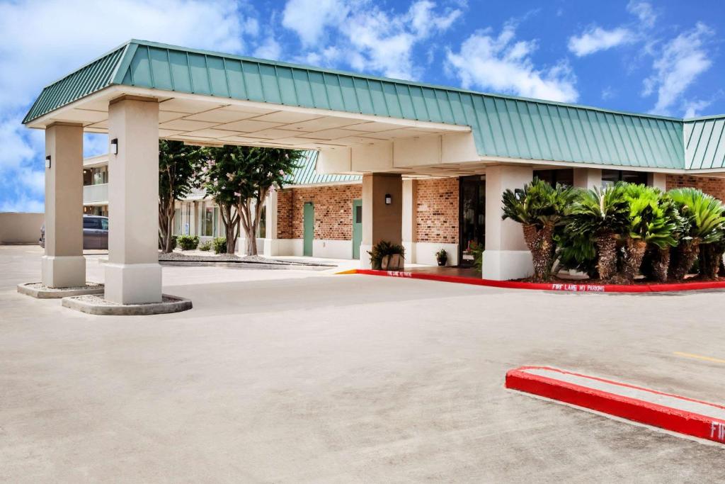 a large building with a green roof at Days Inn by Wyndham Seguin TX in Seguin
