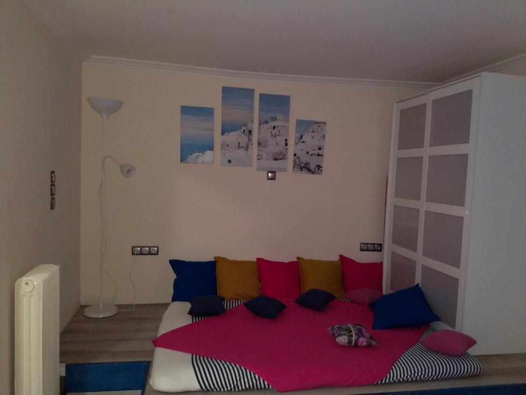 a bedroom with a bed with colorful pillows at Cosy apartment Acropolis Point-3 in Athens