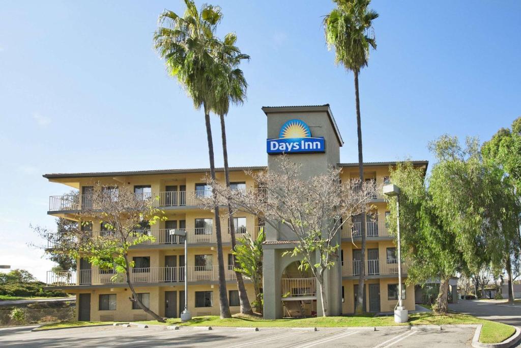 a building with a dallas inn sign on it at Days Inn by Wyndham Buena Park in Buena Park
