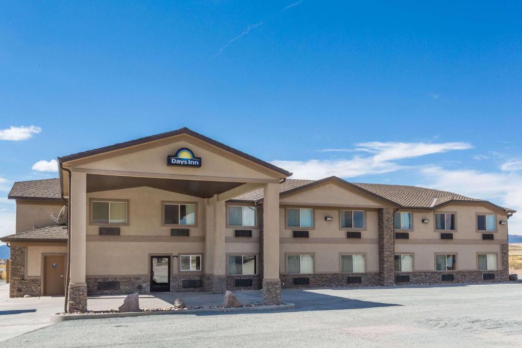 a hotel building with a sign on the front of it at Days Inn by Wyndham Beaver in Beaver