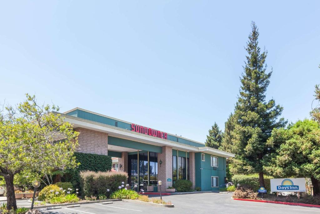 a rendering of the front of a building at Days Inn & Suites by Wyndham Sunnyvale in Sunnyvale