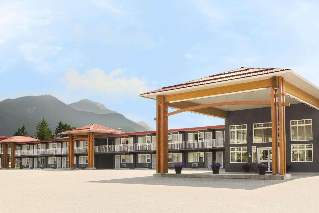 a rendering of a building with mountains in the background at Days Inn by Wyndham Golden in Golden