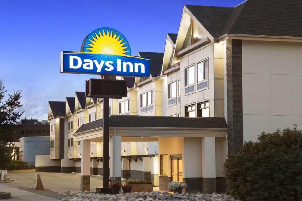 a days inn sign in front of a building at Days Inn by Wyndham Calgary Northwest in Calgary