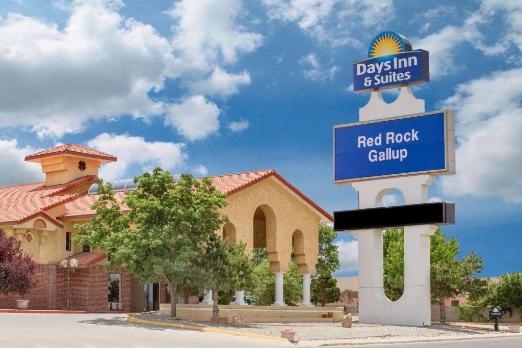 a street sign in front of a field rock gallery at Days Inn & Suites by Wyndham Red Rock-Gallup in Gallup