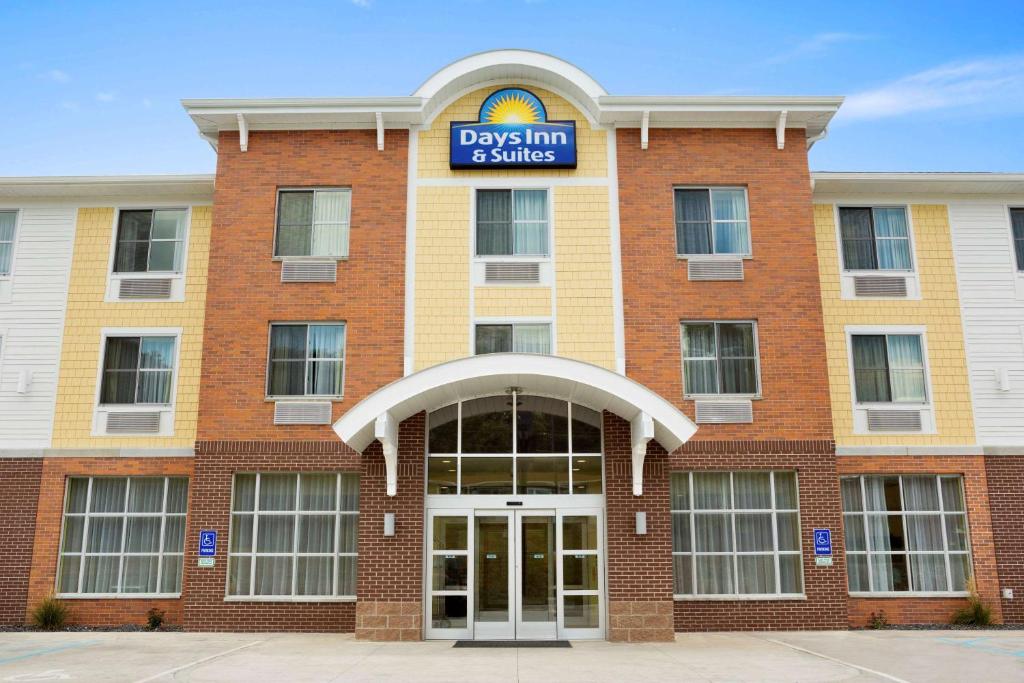 un edificio de ladrillo con un cartel que lee días posada y suites en Days Inn & Suites by Wyndham Caldwell en Caldwell