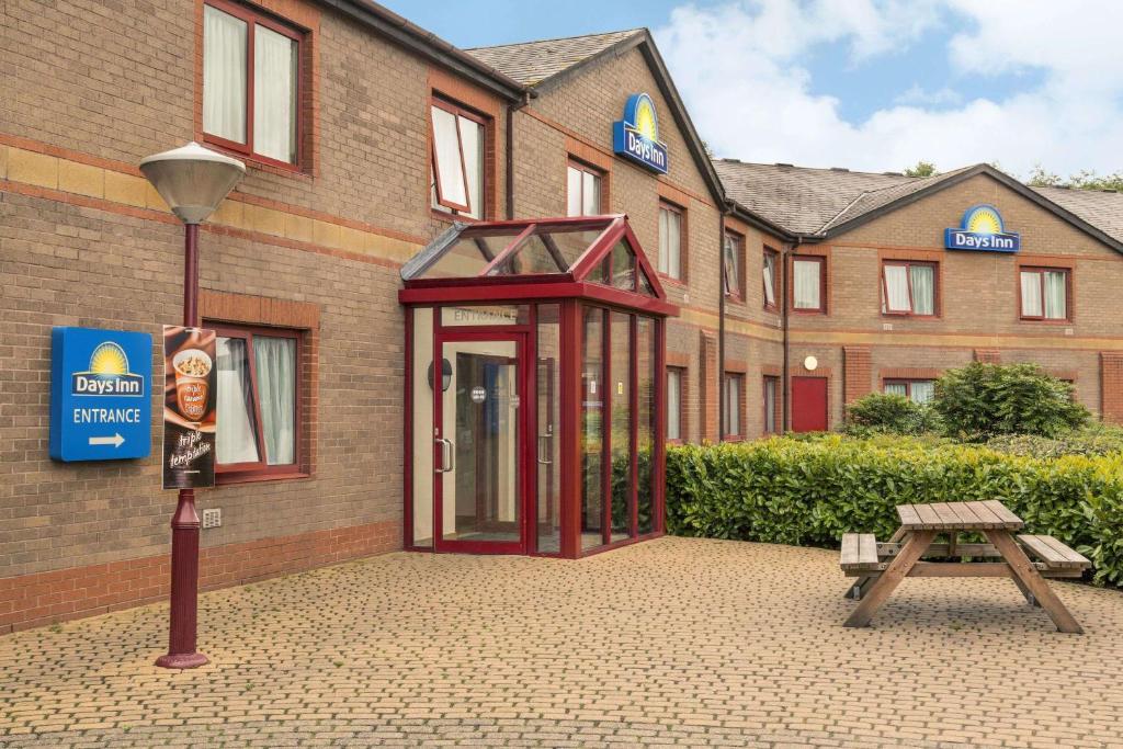 a red phone booth in front of a building at Days Inn Magor in Magor