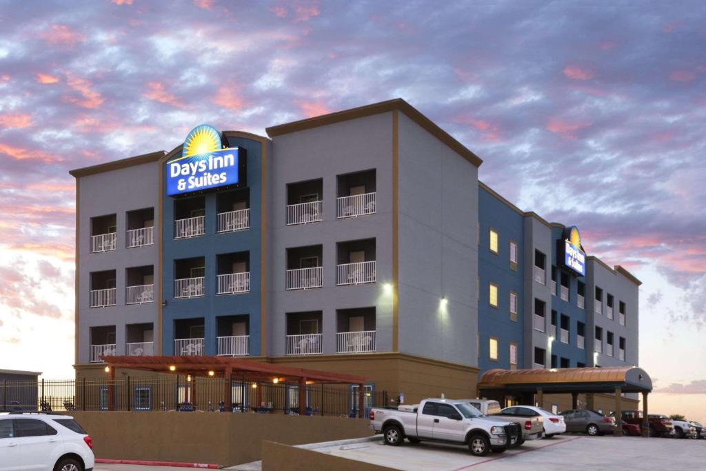 un edificio con un cartel encima en Days Inn & Suites by Wyndham Galveston West/Seawall en Galveston