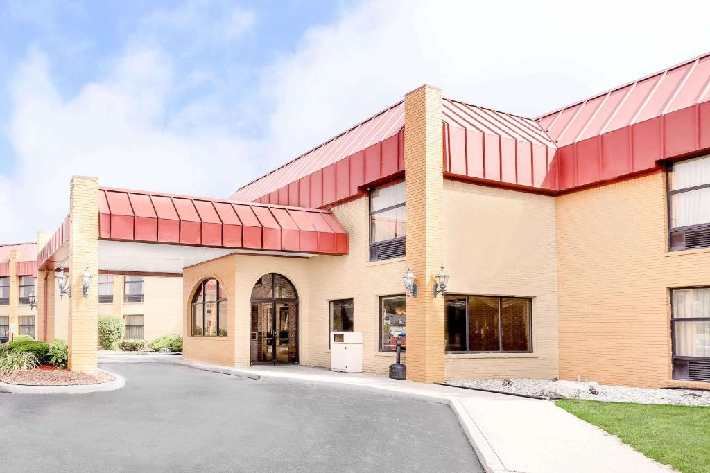 a rendering of the front of a building at Days Inn & Suites by Wyndham Kalamazoo in Kalamazoo