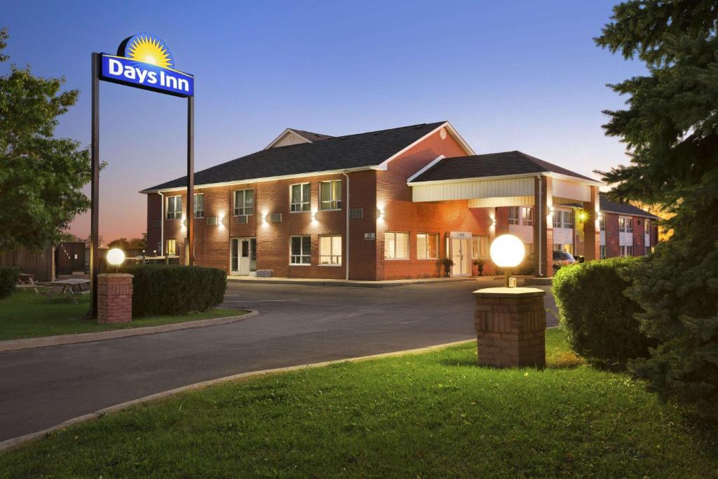 a building with a street sign in front of it at Days Inn by Wyndham Stouffville in Stouffville