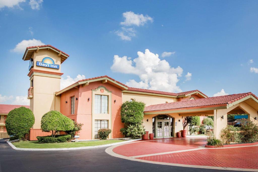 a building with a clock tower on top of it at Days Inn by Wyndham Little Rock/Medical Center in Little Rock