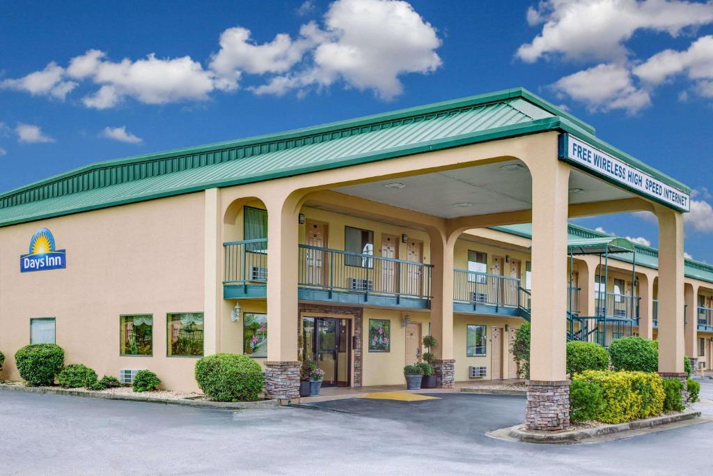 a front view of a hotel with a parking lot at Days Inn by Wyndham Macon I-475 in Macon