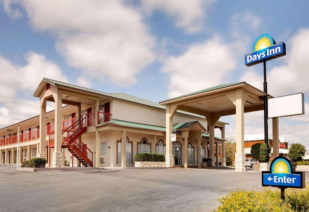 a view of a hotel with a sign in a parking lot at Days Inn by Wyndham San Angelo in San Angelo