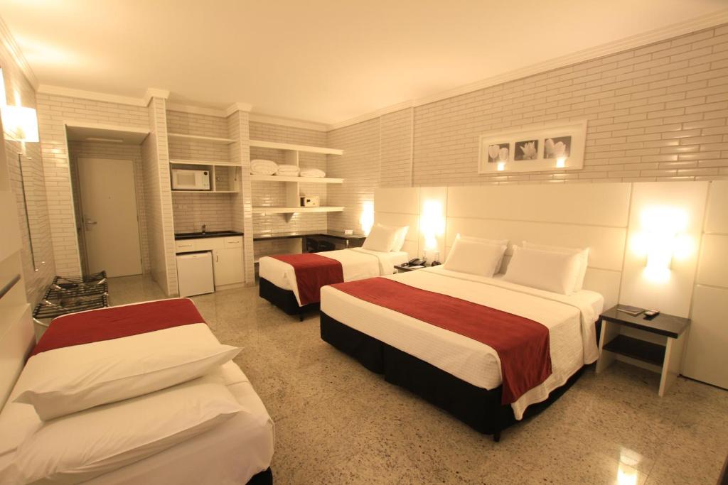 Postel nebo postele na pokoji v ubytování Hotel Confiance Prime Batel