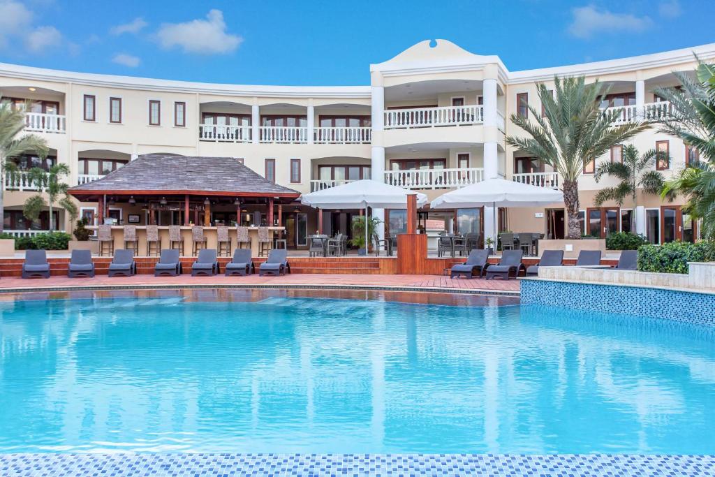 a swimming pool in front of a hotel at Acoya Curacao Resort, Villas & Spa in Willemstad