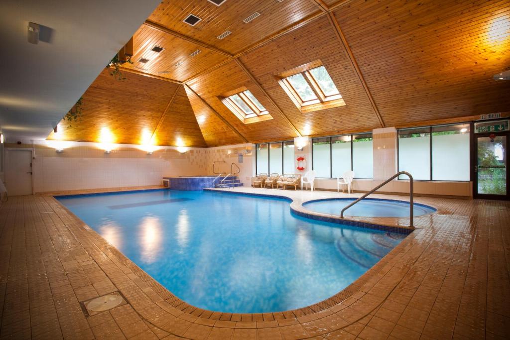 a large swimming pool in a large building at The Waterloo Hotel in Betws-y-coed
