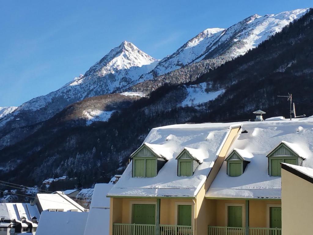 コトレにあるStudio plein centreの山を背景に雪屋根を敷いた建物