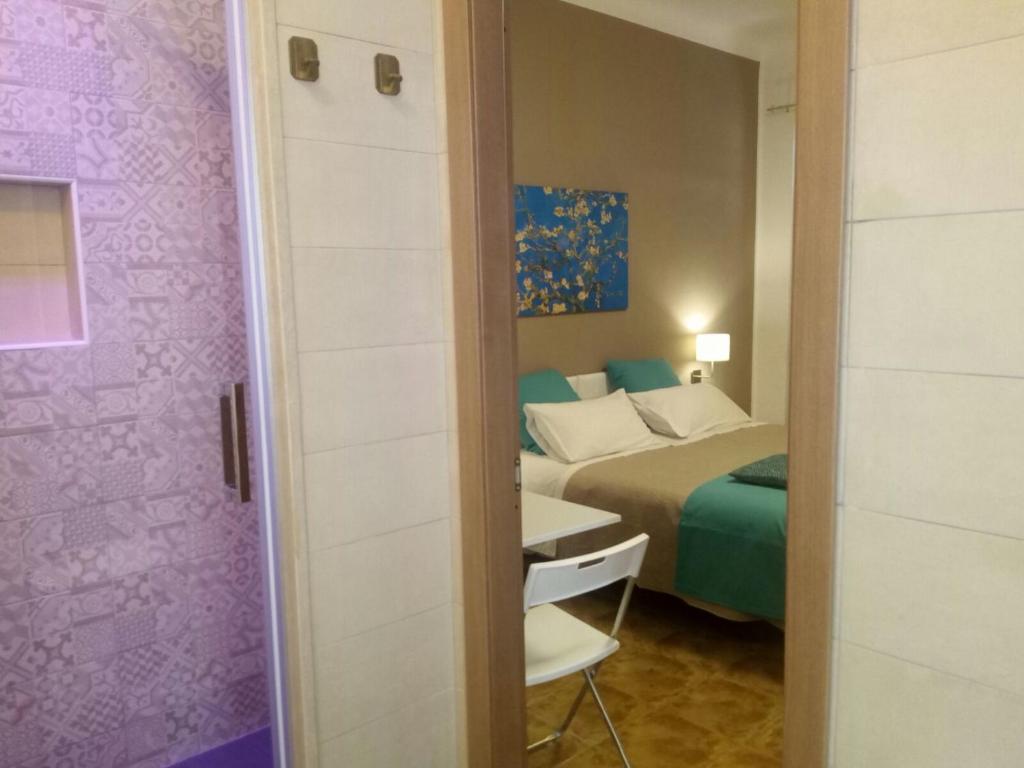 Postel nebo postele na pokoji v ubytování Le Suite dei Due Mari cucinino privato