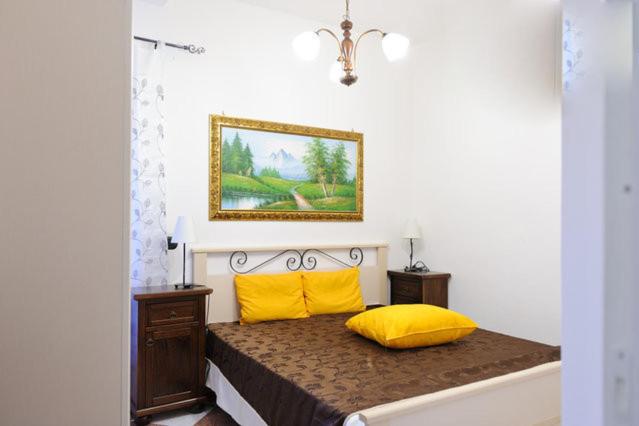 a bedroom with a bed with two yellow pillows at Al Trulletto in Ceglie Messapica