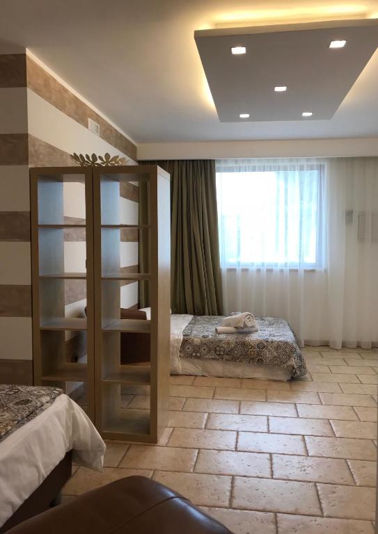 Postel nebo postele na pokoji v ubytování Carone Suite-Charme&Pool
