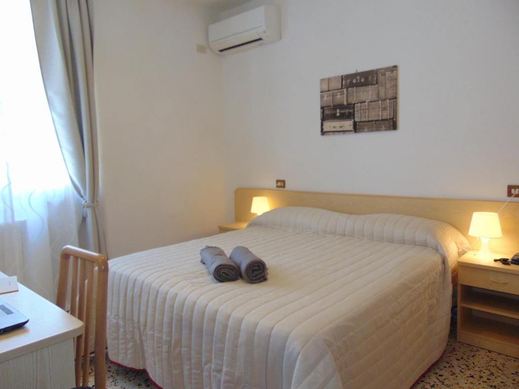 Postel nebo postele na pokoji v ubytování Albergo Rossana