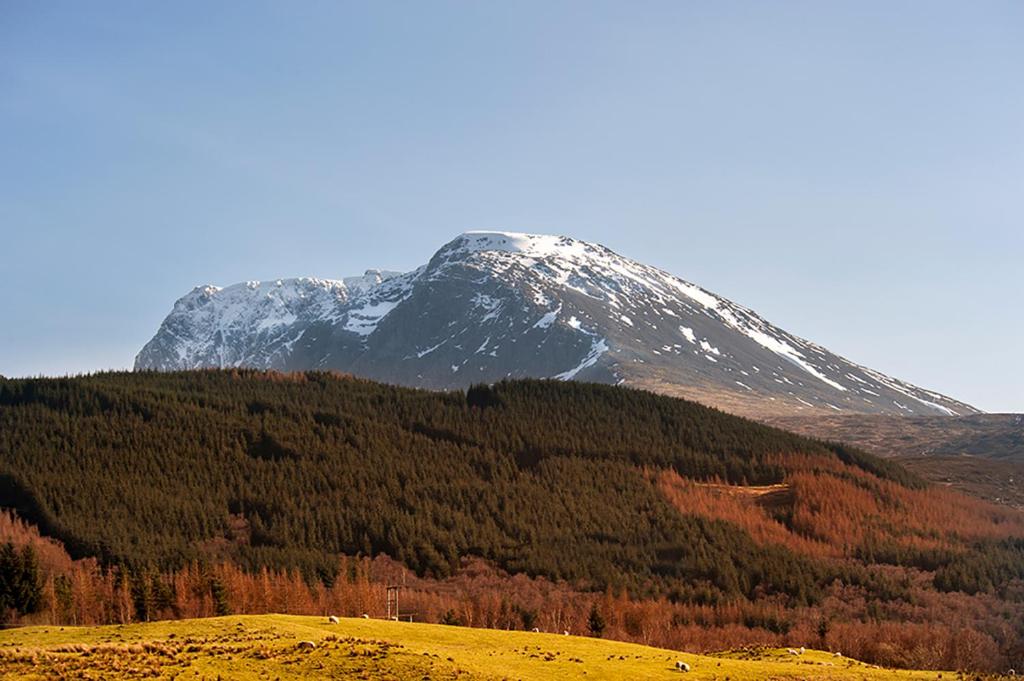 a snow covered mountain on top of a hill at Tower Ridge Courtyard in Fort William