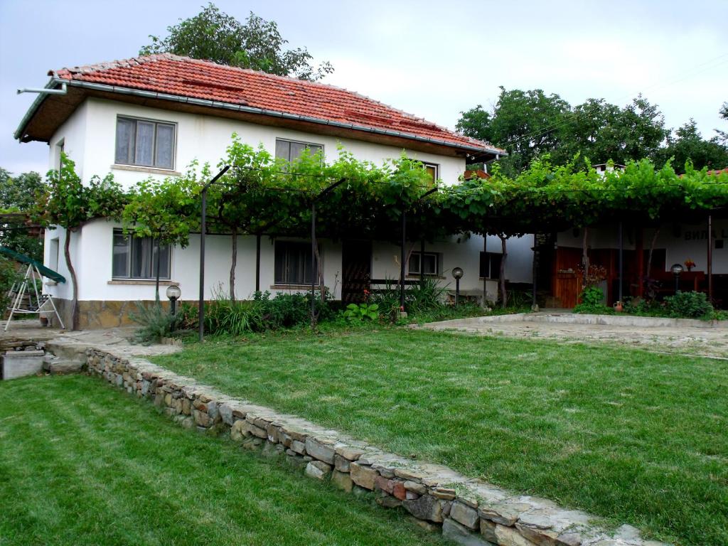 a house with a yard in front of it at Holiday Home Life in Tryavna