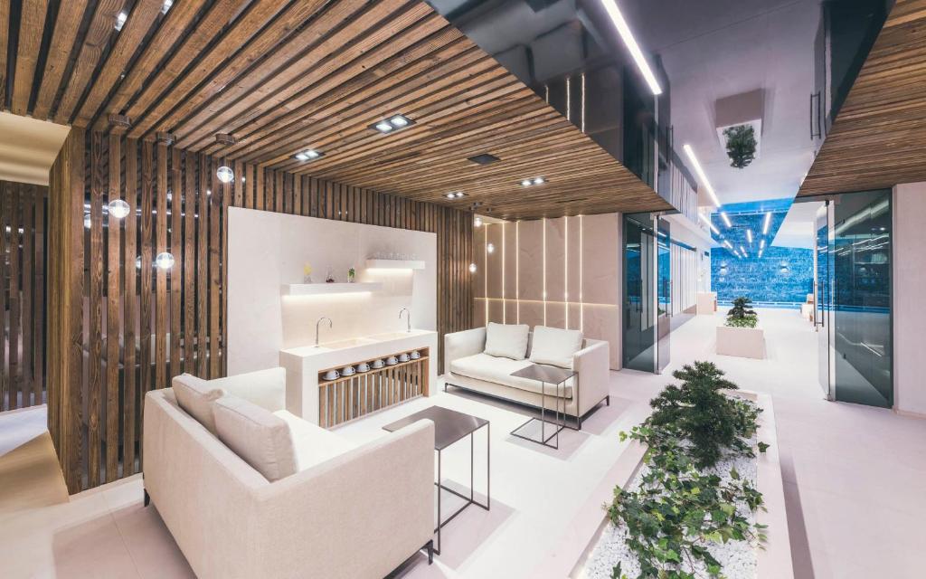 a living room with two couches and a table at Schlosshotel Ischgl 5-Sterne Superior in Ischgl
