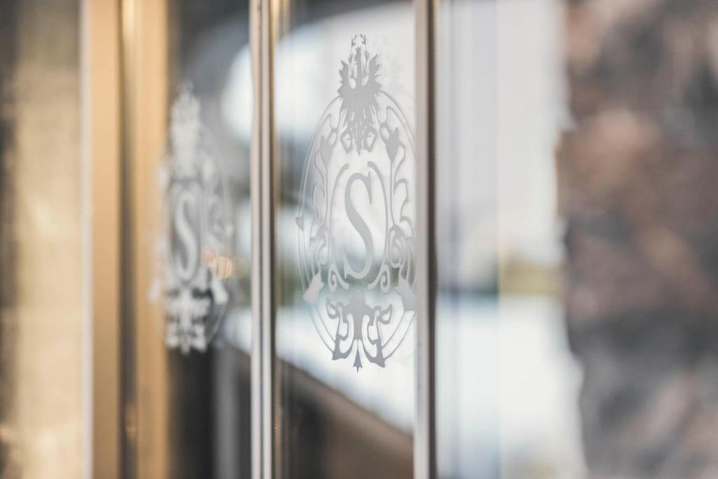 a glass door with a metal design on it at Schlosshotel Ischgl 5-Sterne Superior in Ischgl
