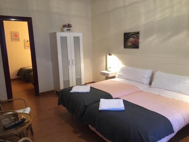 a bedroom with two beds with towels on them at Hotel Covadonga in Ribadesella