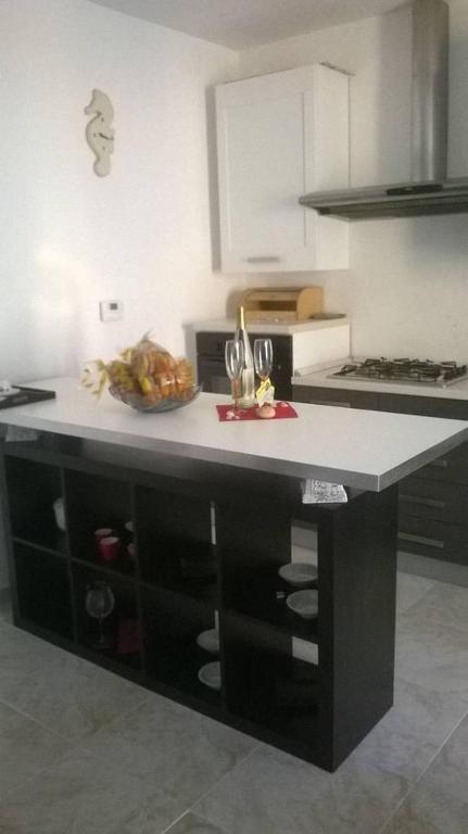 a kitchen with a counter with a bowl of food on it at !!!OFFERTA LAST MINUTE!!! 300m dalla spiaggia in Torre Lapillo