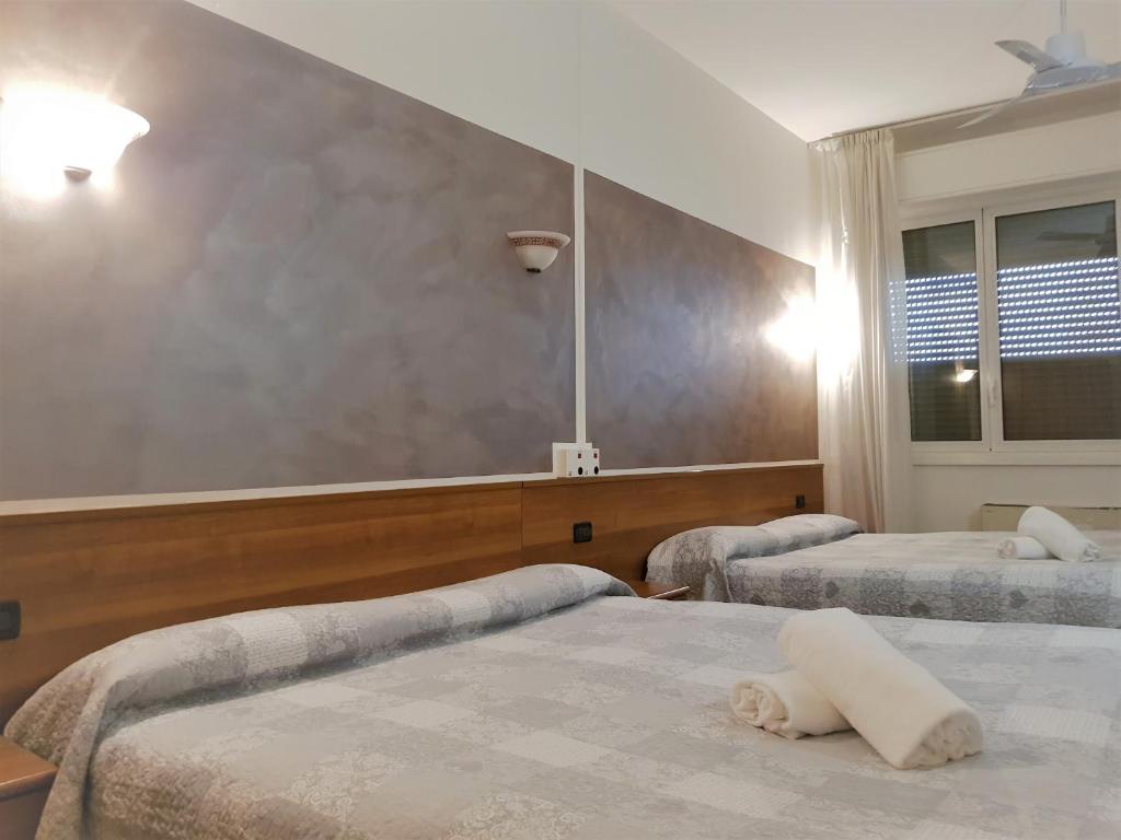 Postel nebo postele na pokoji v ubytování Hotel Marinoni