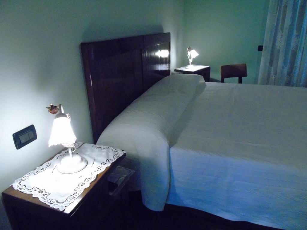 Postel nebo postele na pokoji v ubytování B&B Ai Cipressi